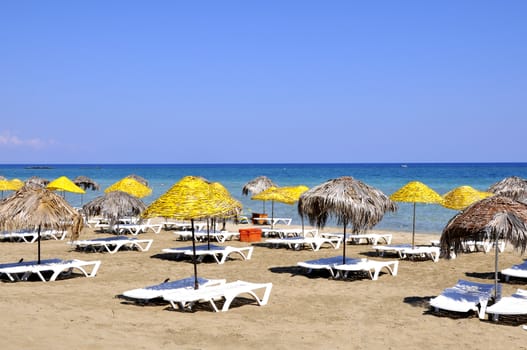 Handmade palm leaf and cane umbrellas on a beautiful Cyprus beach