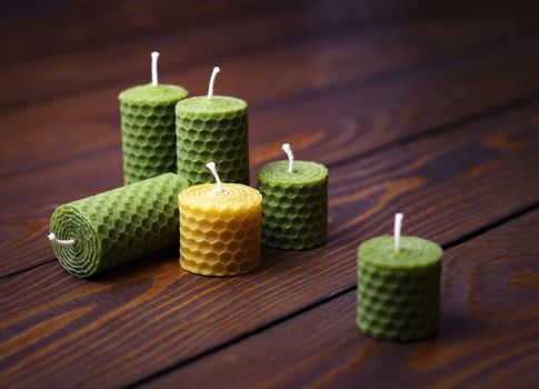 background beeswax candles on a dark wooden table