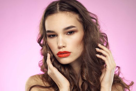 Woman with hairstyle and red lips naked shoulders bright makeup attractive look. High quality photo