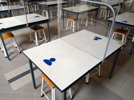 The white dining table has an acrylic plate in the middle to protect Covid-19