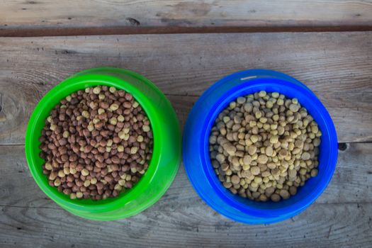 dishes filled with pellets balanced food for dogs