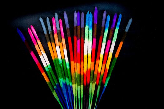 Colored and fragrance handmade incense sticks on black background