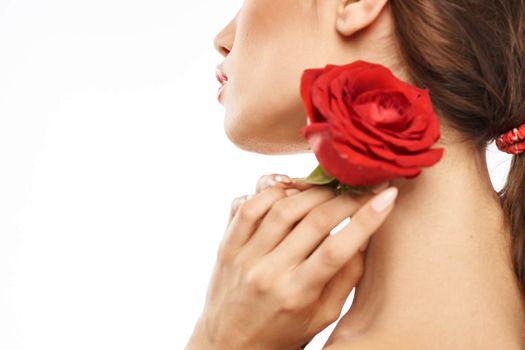 Portrait of woman with red rose naked shoulders Make-up on brunette face. High quality photo