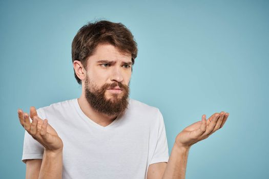 Bearded man emotions white t-shirt lifestyle gestures with hands blue backgrounds. High quality photo