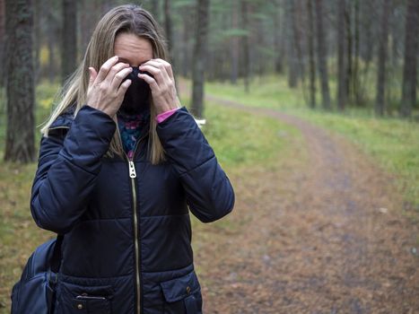 Beautiful european Women Wearing Protective Mask Outside Pretty young girl in medical black face mask in a forest. covid19 concept. modern reality. copy space. 2020, allergy. Autumn season. Copy space