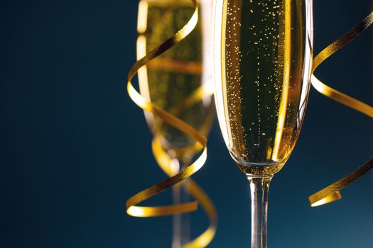 Two glasses of champagne on dark blue background New Year party celebration concept