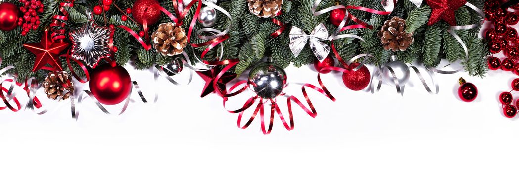 Christmas border frame design copmosition of noble fir tree branch and red silver decorations baubles isolated on white background