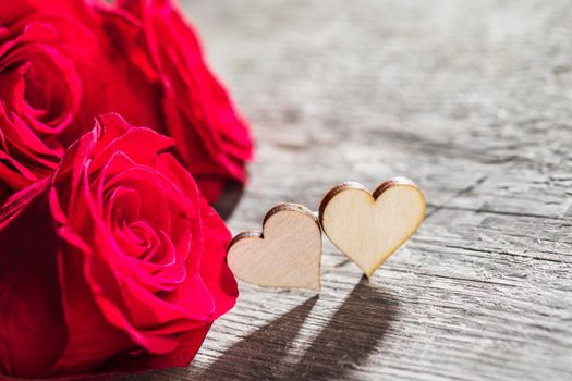 Hearts and red roses on wooden background Valentines day design