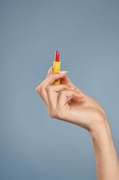 Woman with lipstick on a gray background brunette makeup with eye shadow on the eyelids. High quality photo