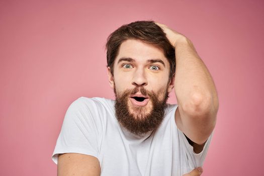 Man in white t-shirt emotions lifestyle facial expression cropped view pink background. High quality photo