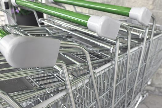 Details of Rows of shopping carts outside waiting to be used.