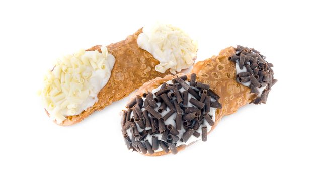 Sicilian cannoli. Three cannoli pastries. Traditional Sicilian dessert, filled with a rich ricotta cream enriched with pistachio grain, hazelnut grain and chocolate flakes.