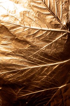 A gold Holographic Foil Leaf and Leaves with Veins Texture Shiny Pattern