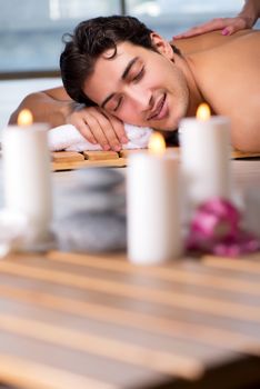 Young handsome man during spa procedure