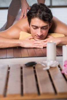 Young handsome man during spa procedure