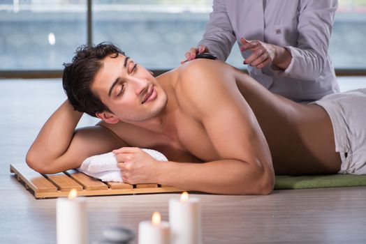 Young handsome man during spa procedure
