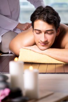 Young handsome man during spa procedure
