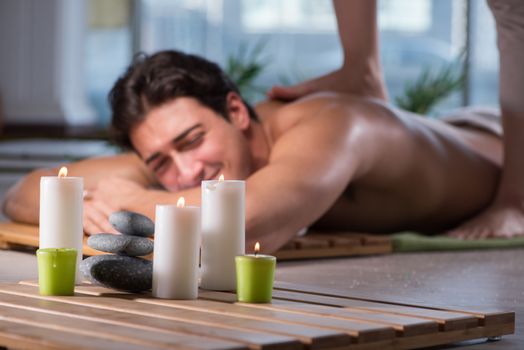 Young handsome man during spa procedure