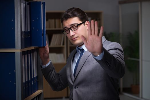 Businessman working late hours in the office