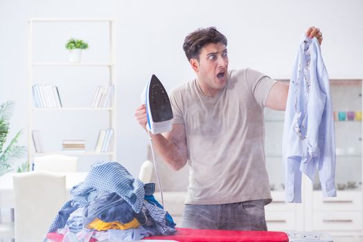Inattentive husband burning clothing while ironing