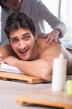 Young handsome man during spa procedure