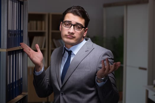 Businessman working late hours in the office