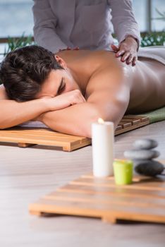 Young handsome man during spa procedure