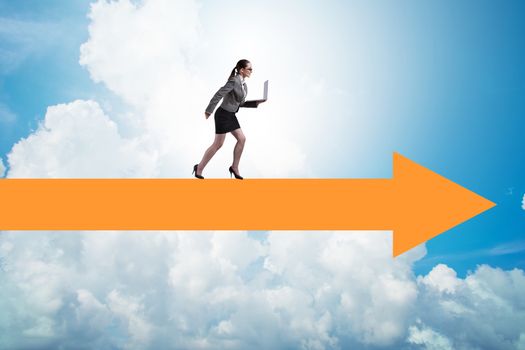 Businesswoman walking on arrow sign