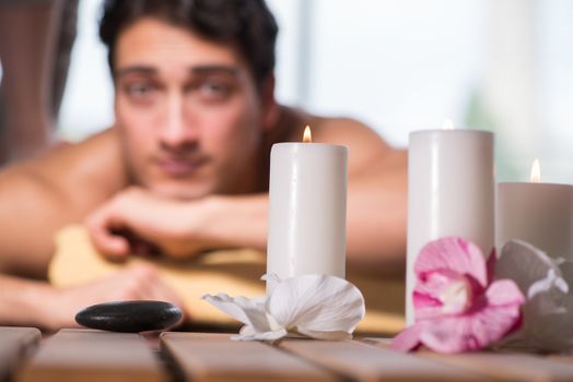Young handsome man during spa procedure