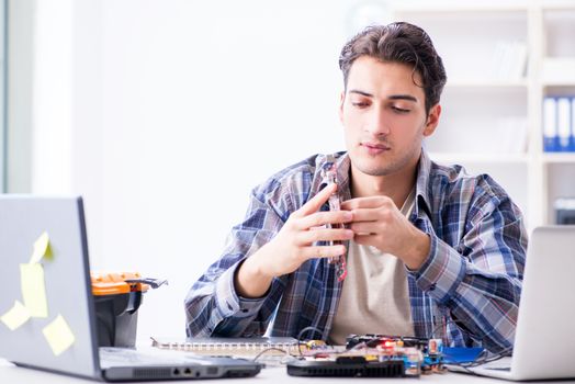 Professional repairman repairing computer in workshop