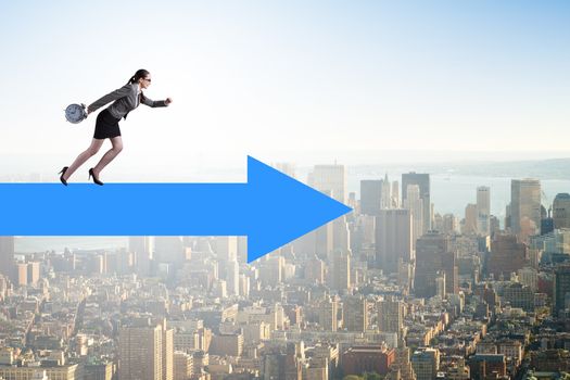 Businesswoman walking on arrow sign