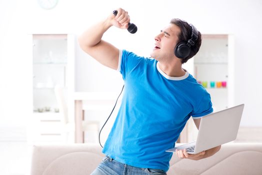 Young man singing at home karaoke