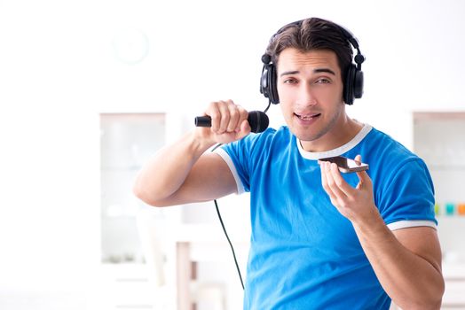 Young man singing at home karaoke