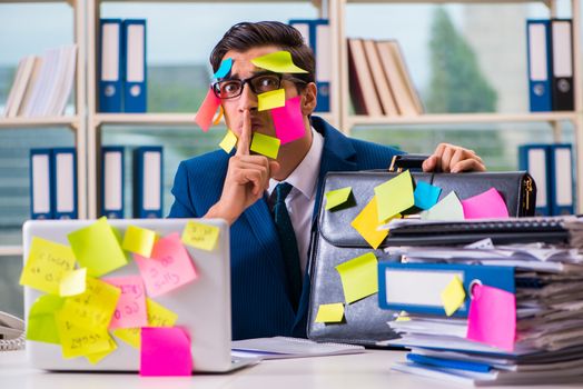 Businessman with reminder notes in multitasking concept