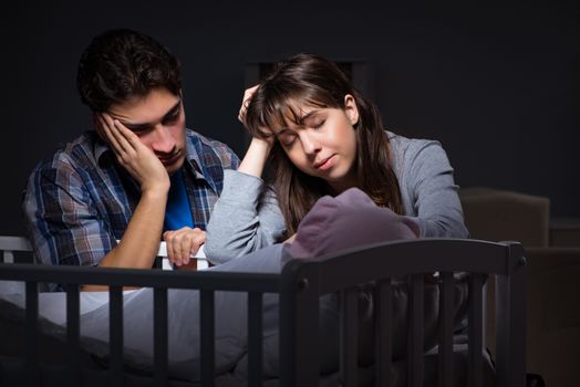 Young parents sleepless with newborn baby at night