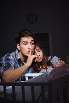 Young parents sleepless with newborn baby at night