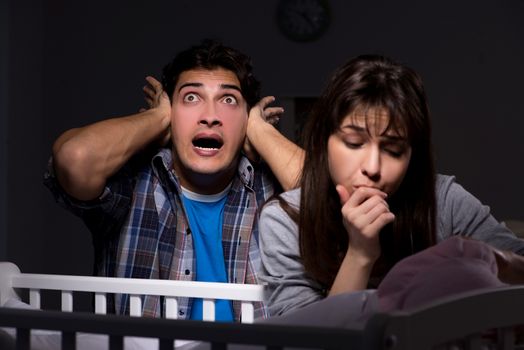Young parents sleepless with newborn baby at night