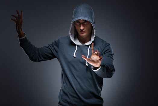 Young man wearing hoodie pressing virtual buttons