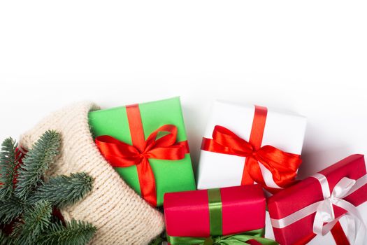 Christmas stocking red and white knitted handmade woolen sock fir tree and gifts isolated on white background