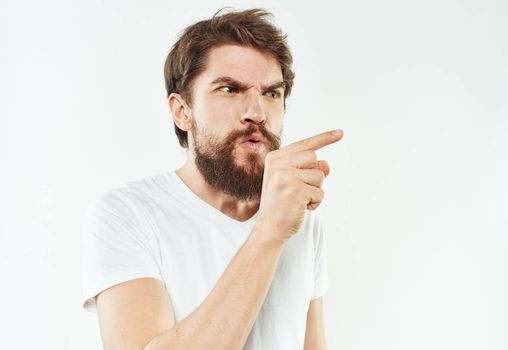 Portrait of a man emotions white t-shirt thick beard. High quality photo