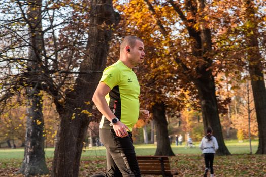 11/14/2020. Park Stromovka. Prague czech Republic. A man is running in the park on a Sunday winter day.