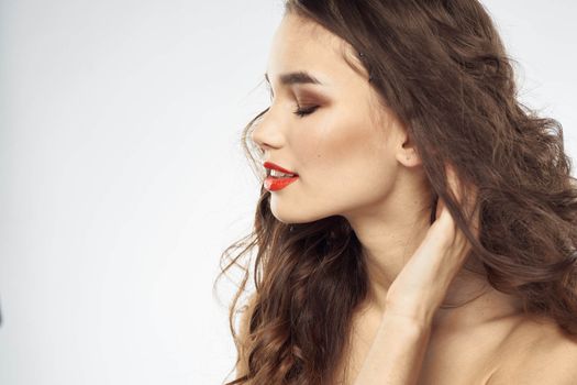 Elegant woman with bare shoulders red lips glamor attractive look cropped look. High quality photo