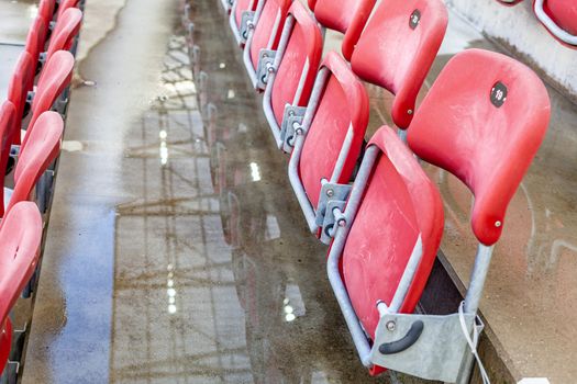 empty red chairs in the outdoor arena.