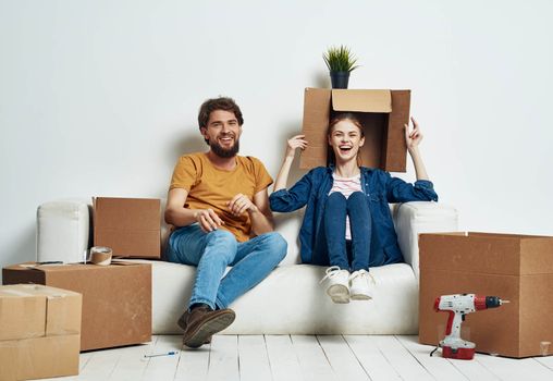 Housewarming couple moving to a new apartment boxes with things. High quality photo