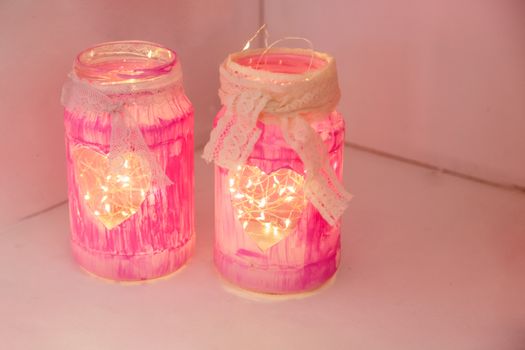 Transparent glass jar with garlands valentine's day decoration.