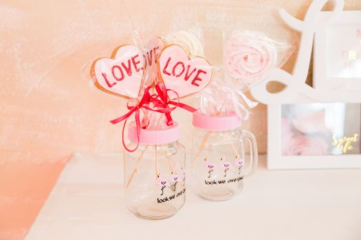 Sweets on a stick in a transparent glass jar valentine's day decoration.