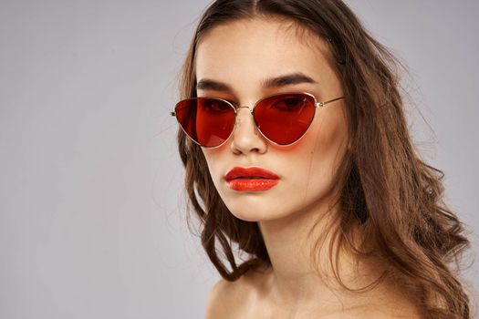 Fashionable brunette in sunglasses with makeup lipstick model. High quality photo