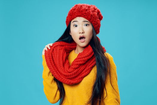 Surprised woman in knitted hat and scarf with open mouth looking to the side