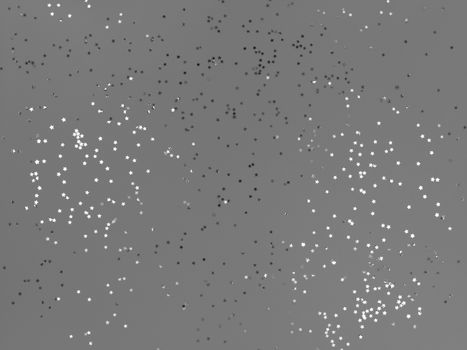 Confetti stars sparkling on grey background.