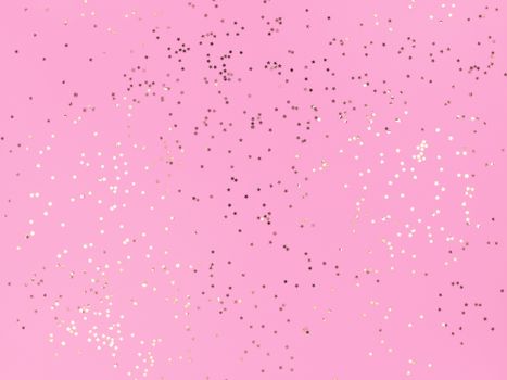 Confetti stars sparkling on pink background.